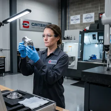 Technician inspecting machined medical part