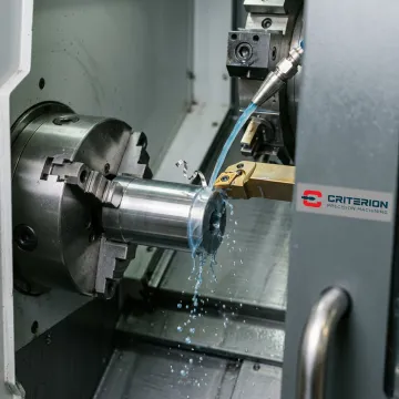 Precision CNC turning machine producing a metal component