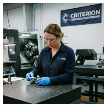 Precision machinist inspecting aerospace component