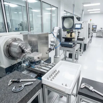 Precision medical device components being machined on CNC equipment