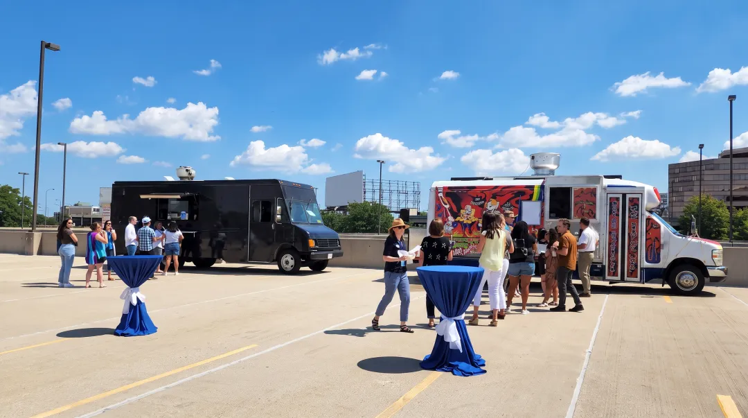 Food trucks lined up at corporate event serving employees during outdoor lunch