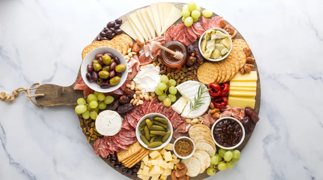 Professionally arranged charcuterie board showing proper spacing texture variety and visual balance