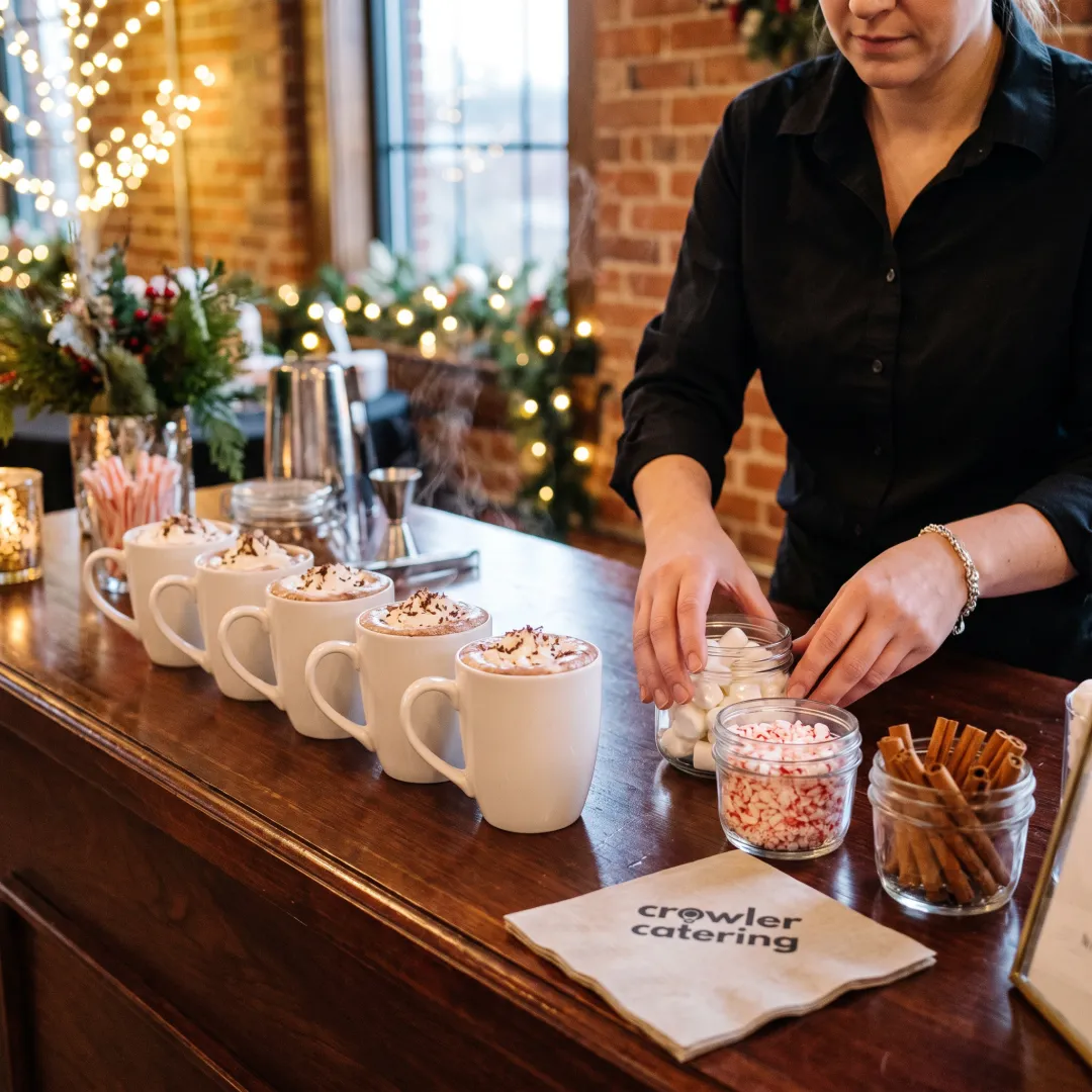 Caterer preparing hot chocolate for guests