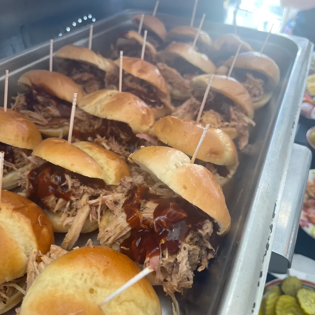 Assorted sliders and appetizers on a catered party table