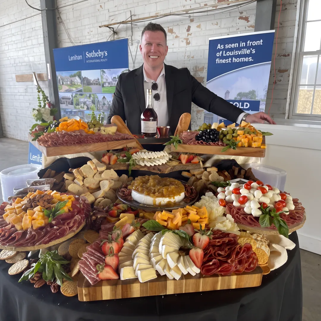 Abundant charcuterie grazing table with cheeses and fruit