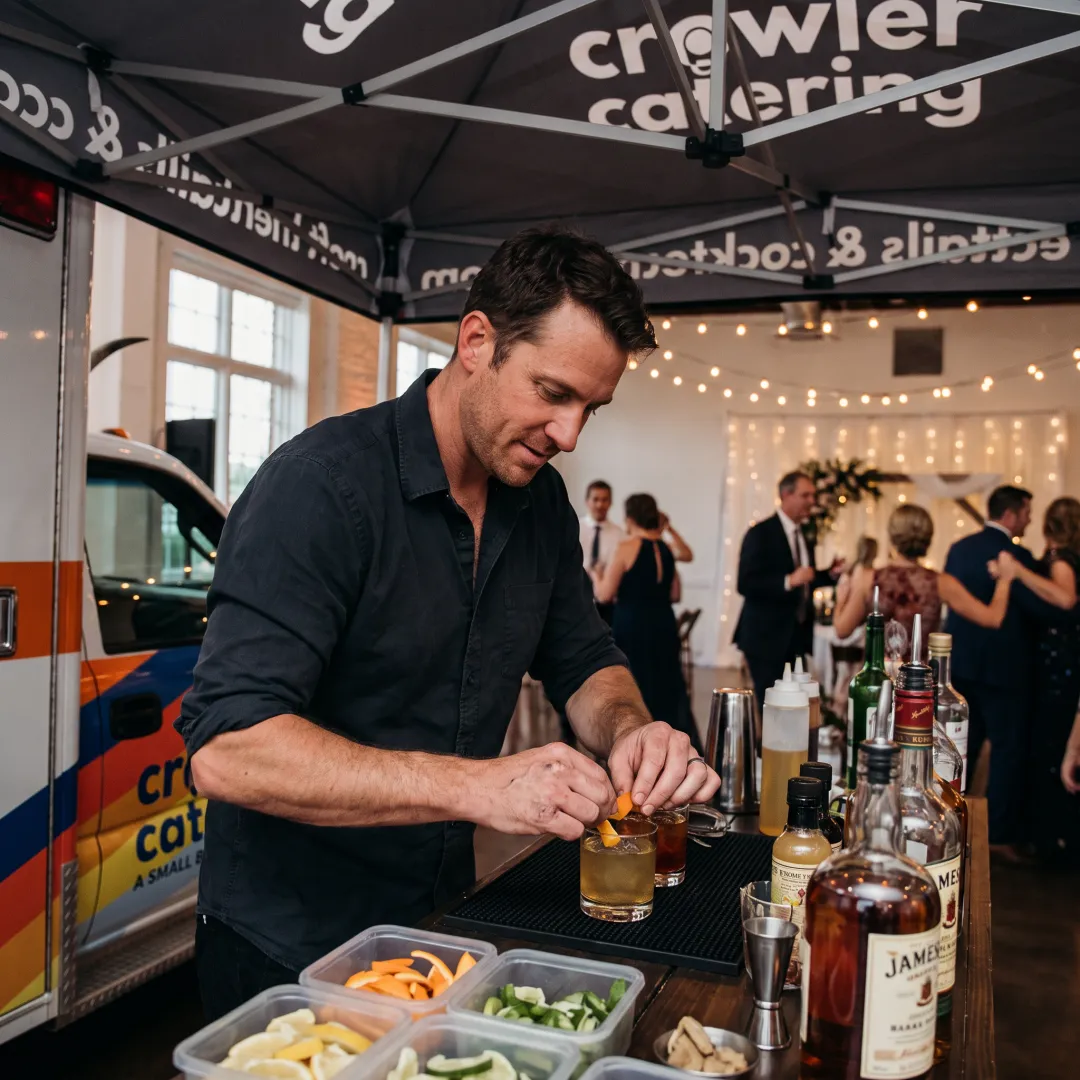 Bartender preparing a custom cocktail at mobile bar