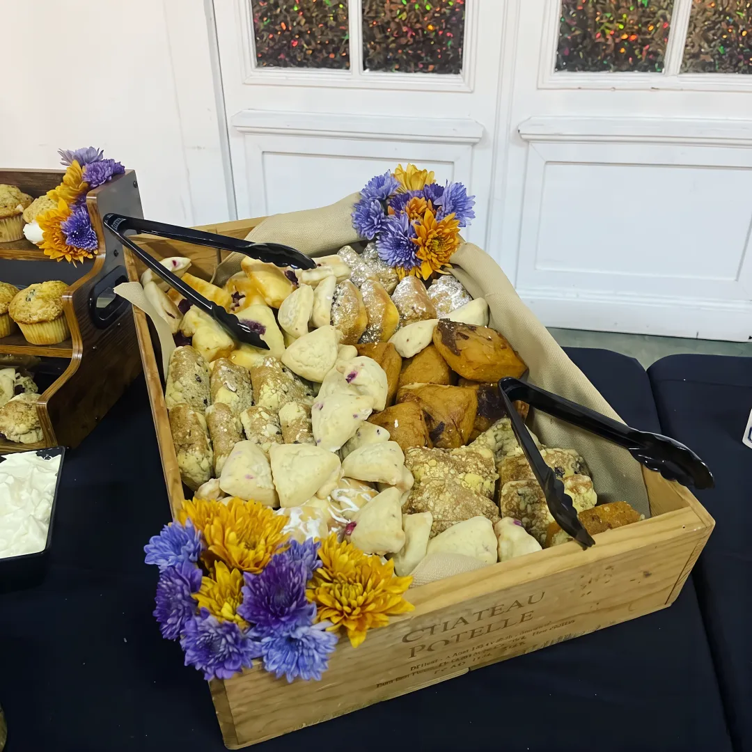 Catered breakfast spread with burritos and fresh fruit