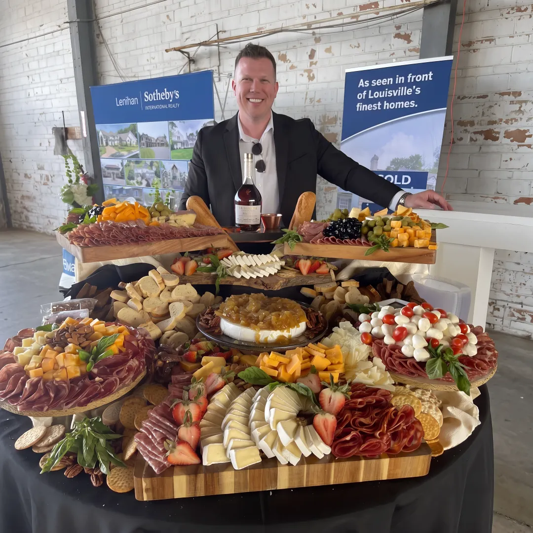 Caterer arranging a charcuterie display for guests
