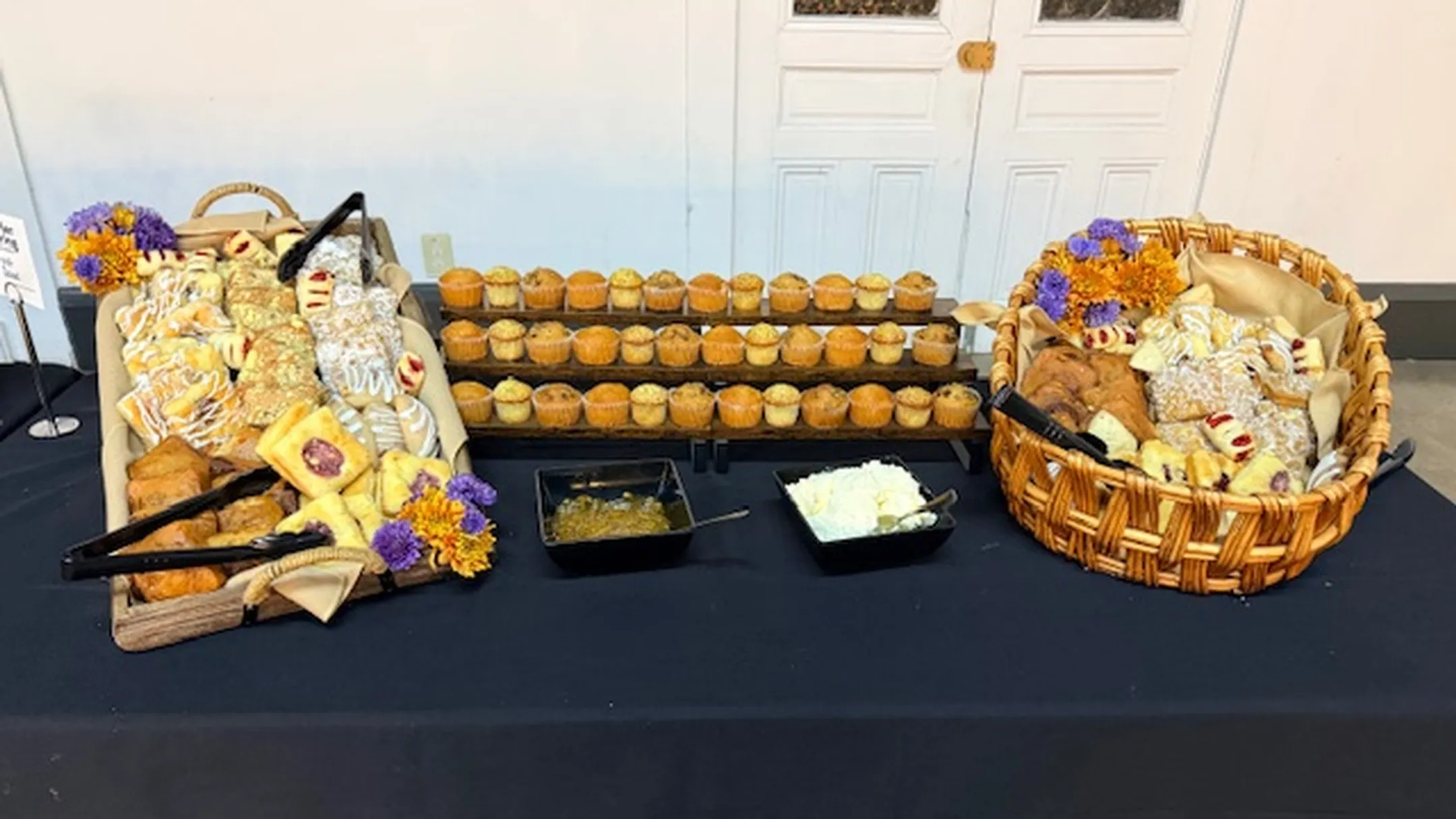 Elegant corporate dessert display with individual portions mini cheesecakes and chocolate mousse cups