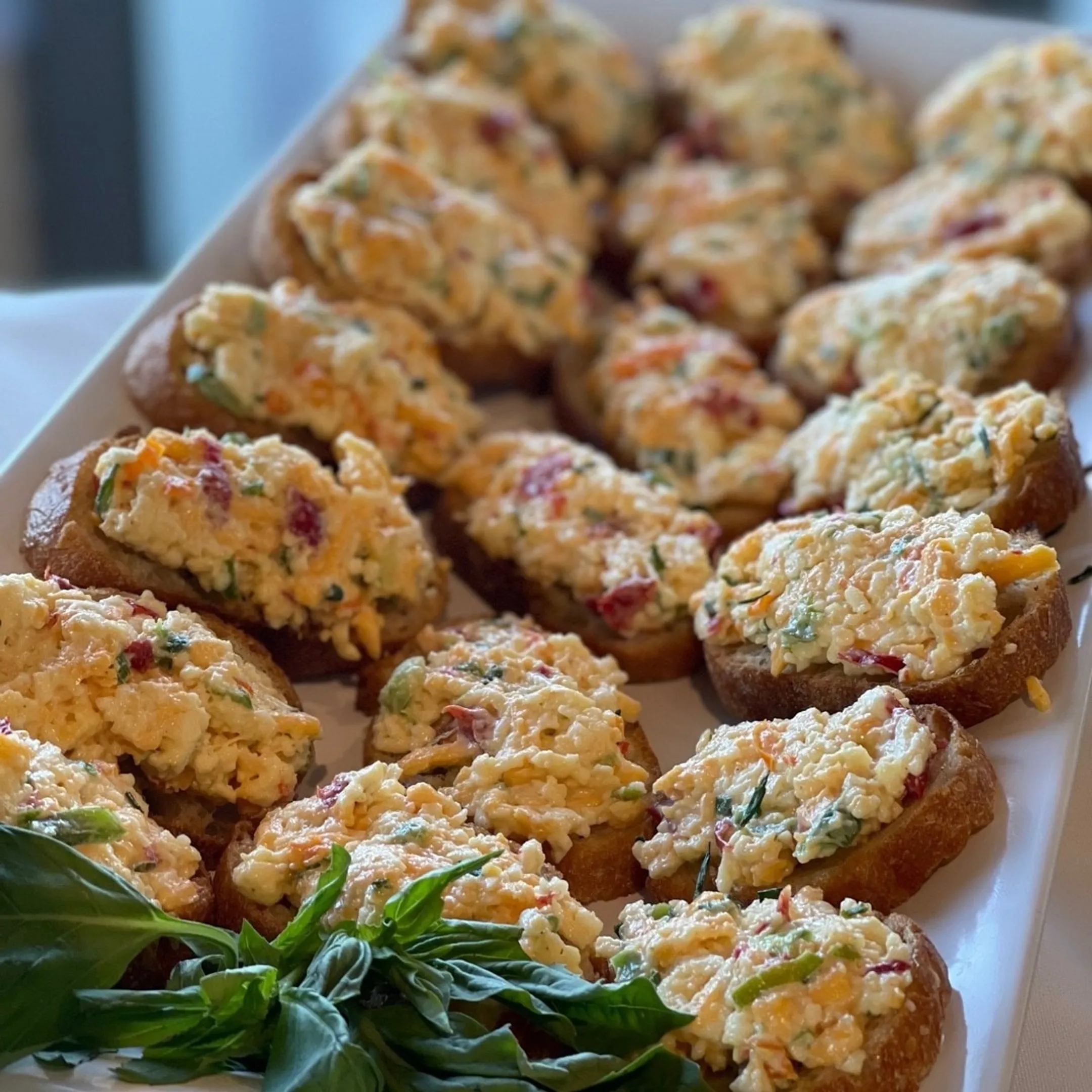 Catered canapé display with charcuterie and cocktails