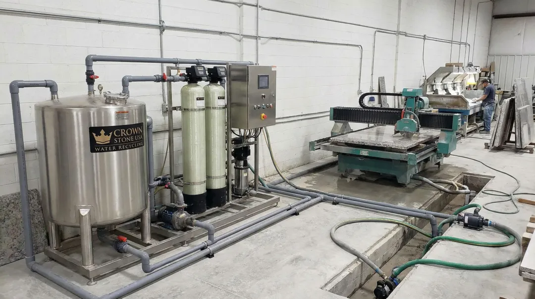 Crown Stone USA water recycling system supporting multiple bridge saws and polishers