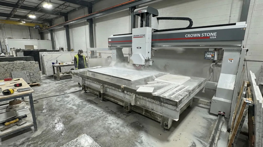 Crown Stone USA bridge saw machine on fabrication shop production floor