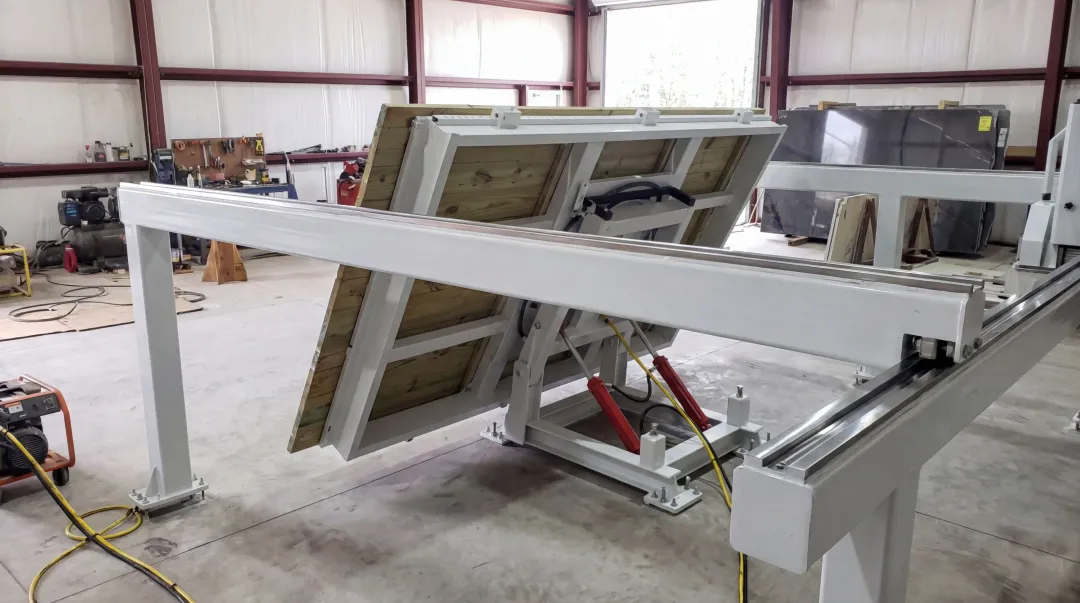 Crown Stone USA bridge saw table with CNC-machined rolling surfaces and hydraulic lift system