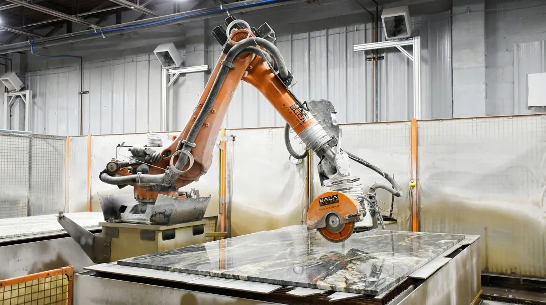 6-axis robotic arm performing automated stone slab cutting in fabrication facility