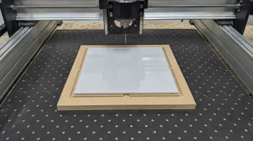 CNC router vacuum table with ceramic tile secured on sacrificial spoilboard