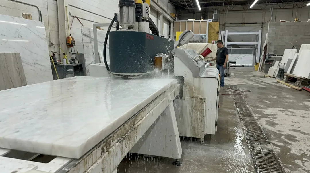 Crown Stone automated edge polisher with water recycling system in fabrication shop
