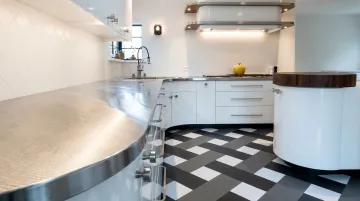 Brushed stainless steel kitchen countertop with directional grain finish installed