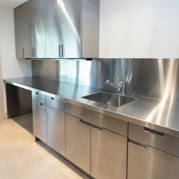 Custom stainless steel kitchen cabinets installed in a modern kitchen