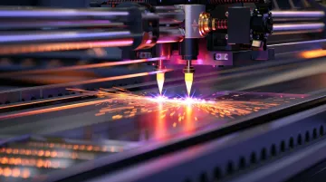 Industrial fiber laser cutting machine processing metal sheet in manufacturing facility