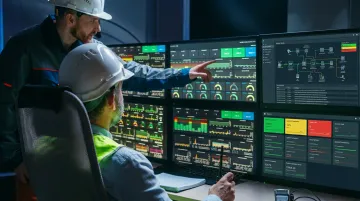 Industrial OT control room with cybersecurity monitoring screens and operational technology systems
