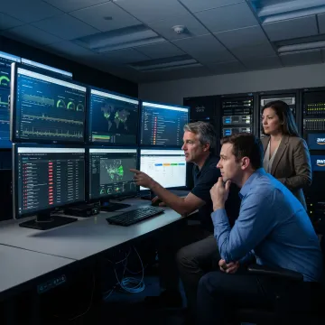 IT specialists reviewing enterprise monitoring dashboards