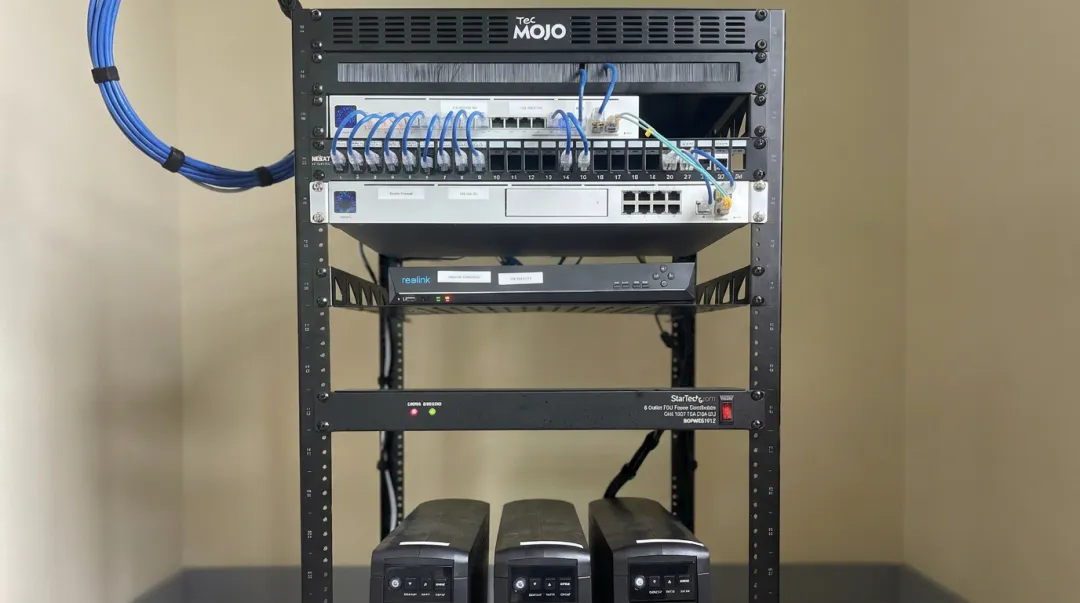 Organized server room rack with patch panel switches and UPS equipment installed