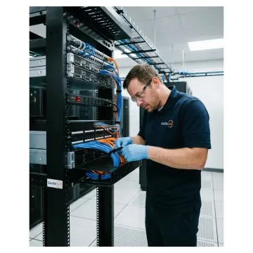Technician organizing data center network cables