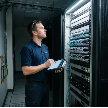 Technician documenting server rack connections