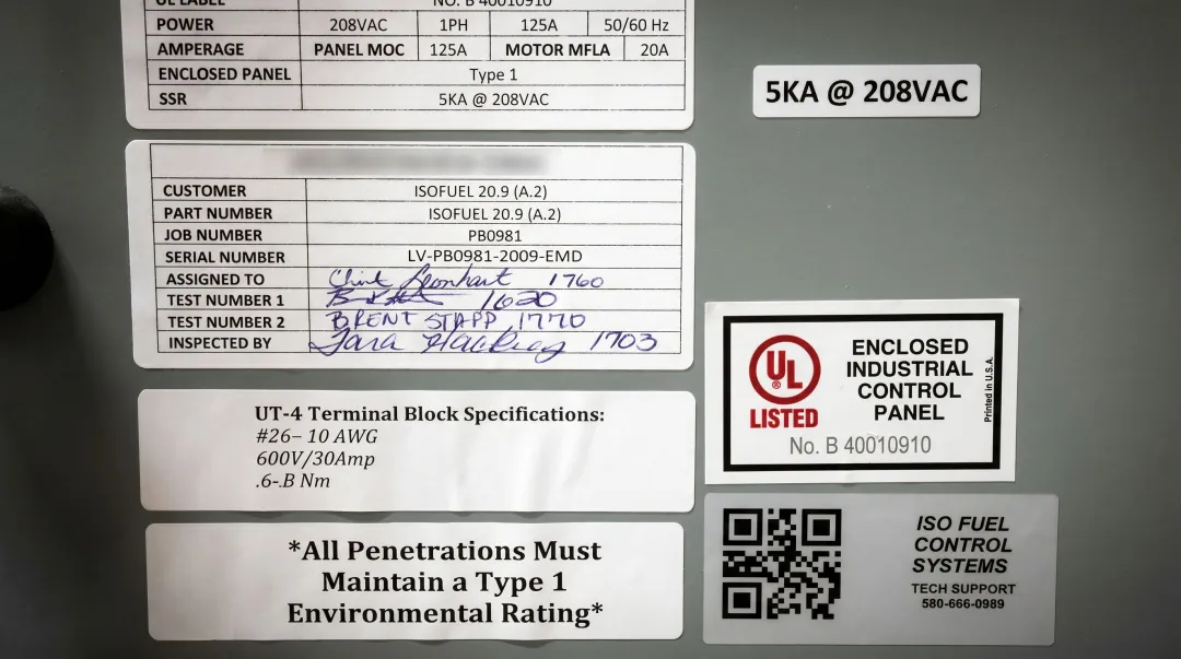 NEC code compliance documentation and electrical panel certification labels on switchboard