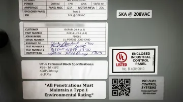 NEC code compliance documentation and electrical panel certification labels on switchboard