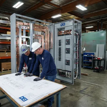 Engineers reviewing industrial switchgear design