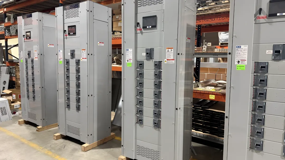 Electrical inspector verifying UL Listed switchboard certification mark on nameplate