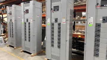 Electrical inspector verifying UL Listed switchboard certification mark on nameplate