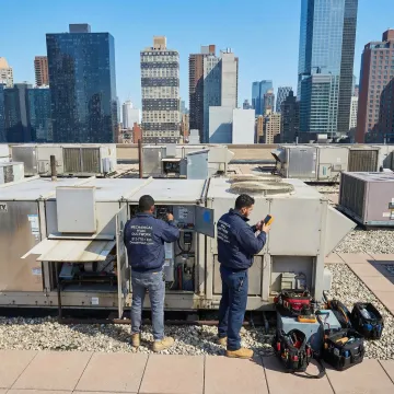 HVAC technicians servicing commercial HVAC equipment in a Manhattan property