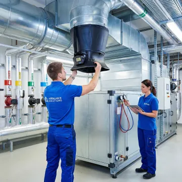 HVAC technicians performing system commissioning and testing in a commercial building