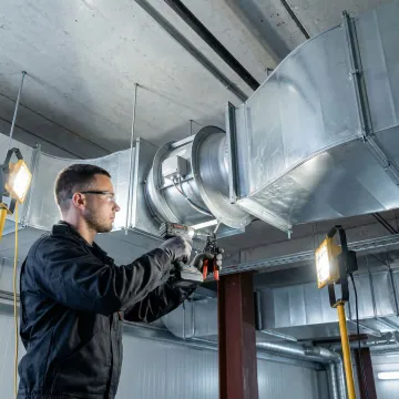 Inline axial duct fan installation in a Manhattan commercial building