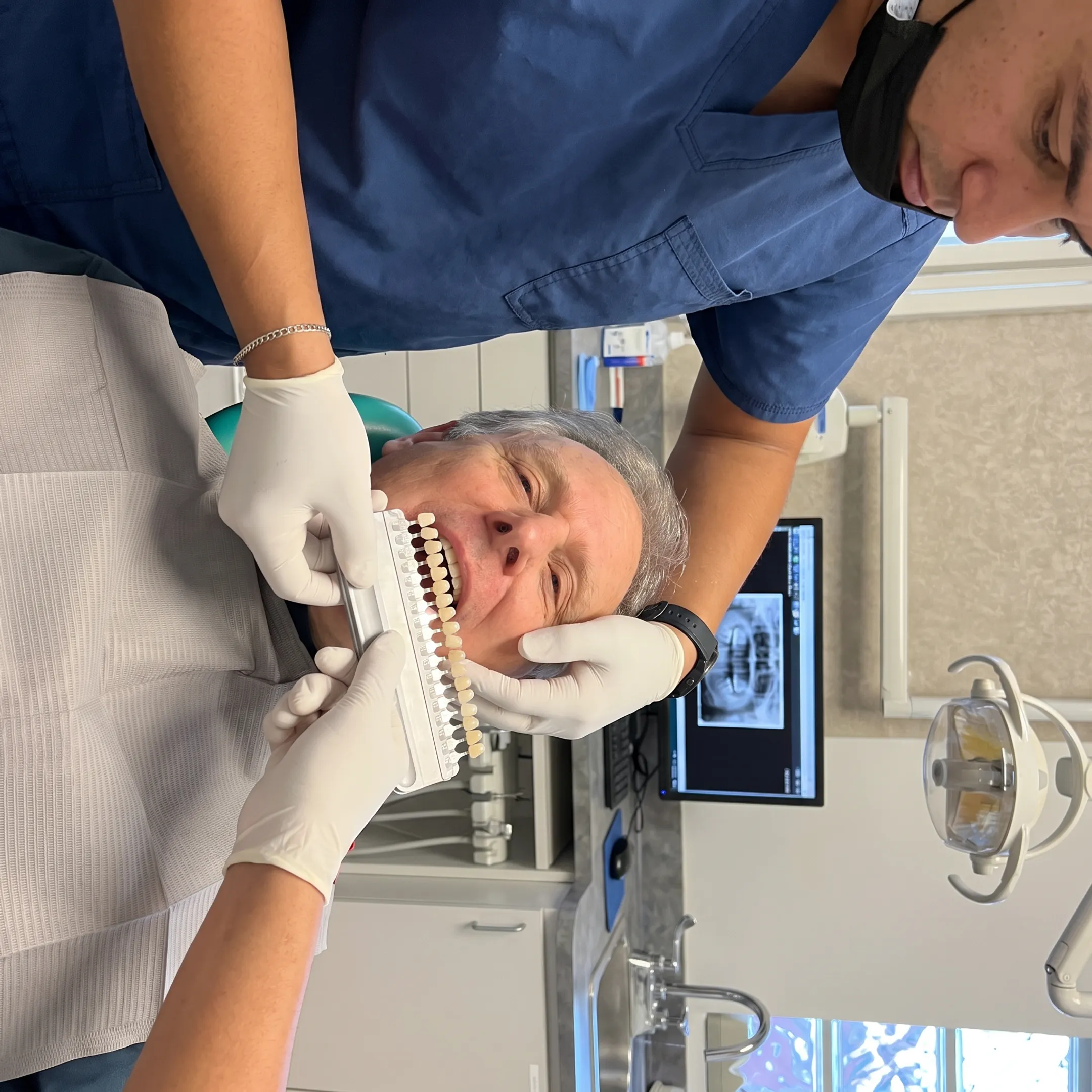 Dentist matching porcelain veneer shades for a patient