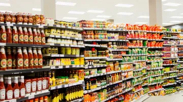 Retail grocery shelf aisle showing dense competing food product packaging