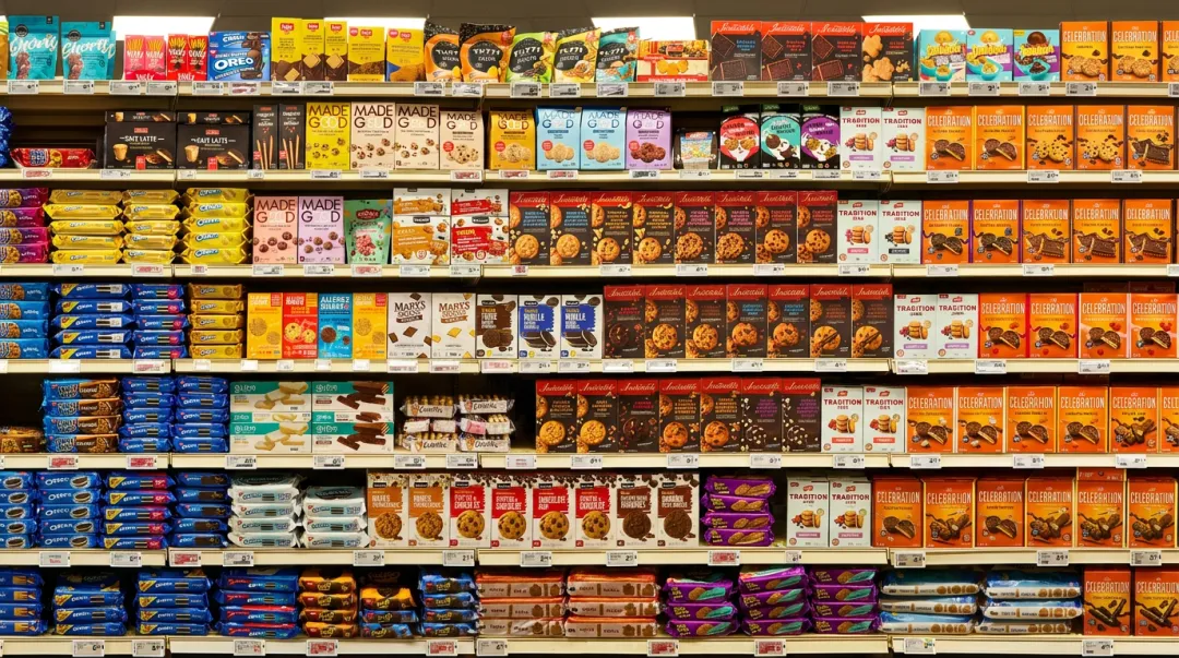 Crowded grocery store shelf with competing food brand products side by side