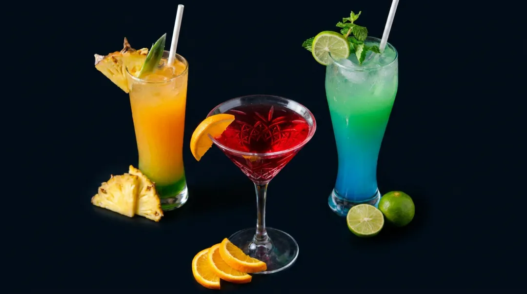 Beverage photography flat lay showing drink with contrasting garnish and props on dark surface