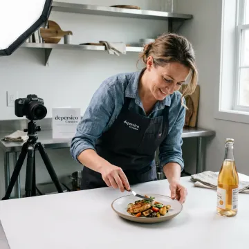 Food stylist preparing product photography shoot