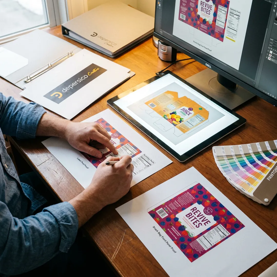 Designer reviewing custom food label proofs