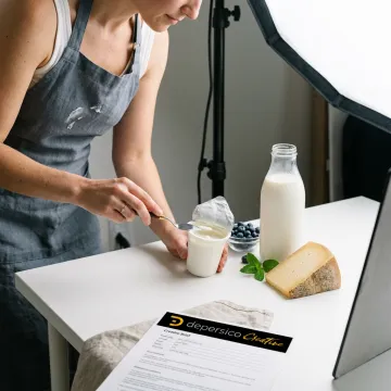 Food photographer styling dairy product for packaging shoot