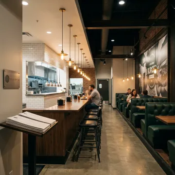 Modern burger restaurant interior with booths and counter seating