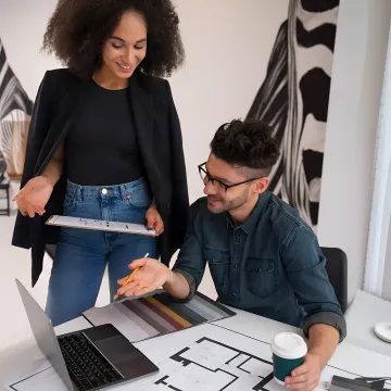 Designer reviewing remodel plans and materials with homeowners