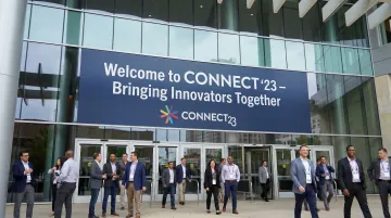 Large convention hall entrance with oversized welcome banner spanning full width