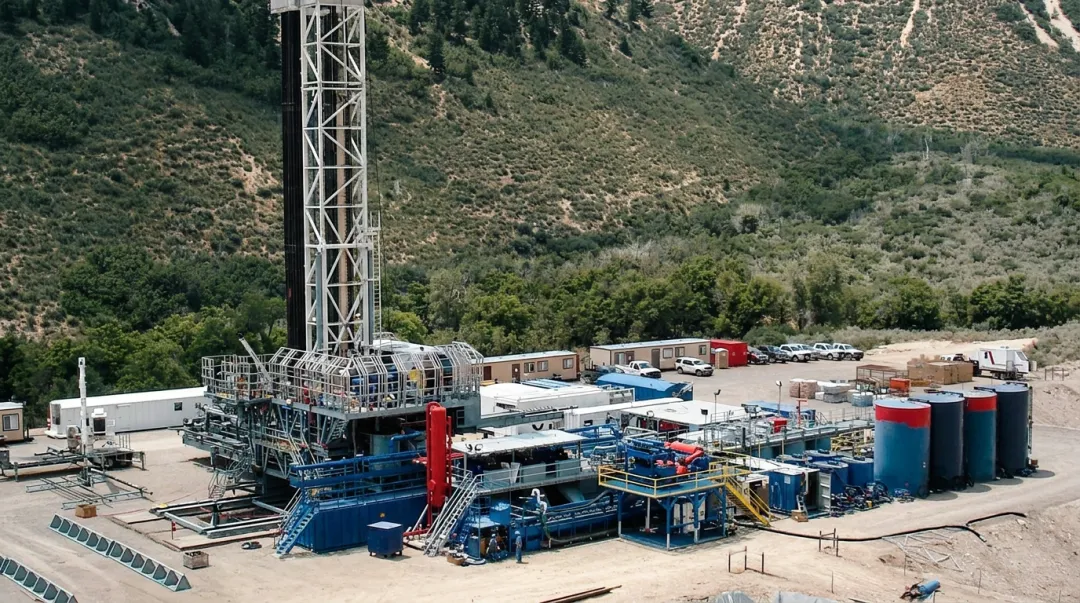 Horizontal directional oil well drilling rig operating in oilfield with derrick visible