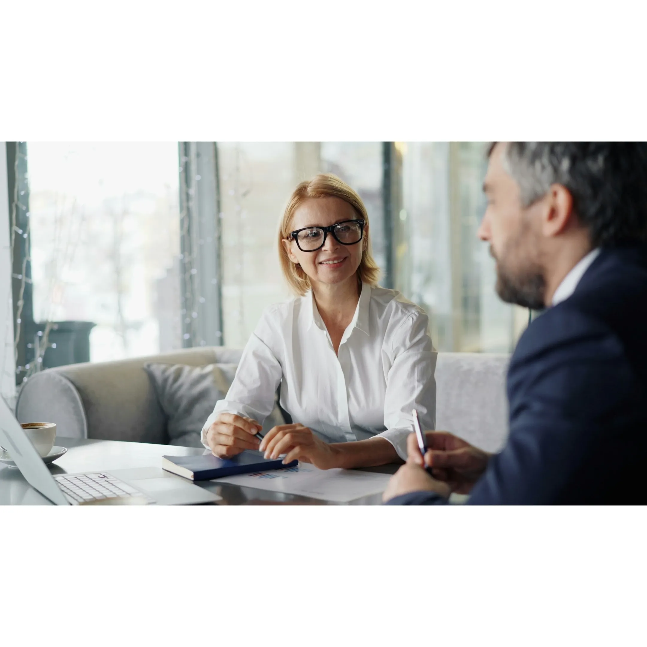 Direct mail marketing materials and financial consultation postcards on a desk
