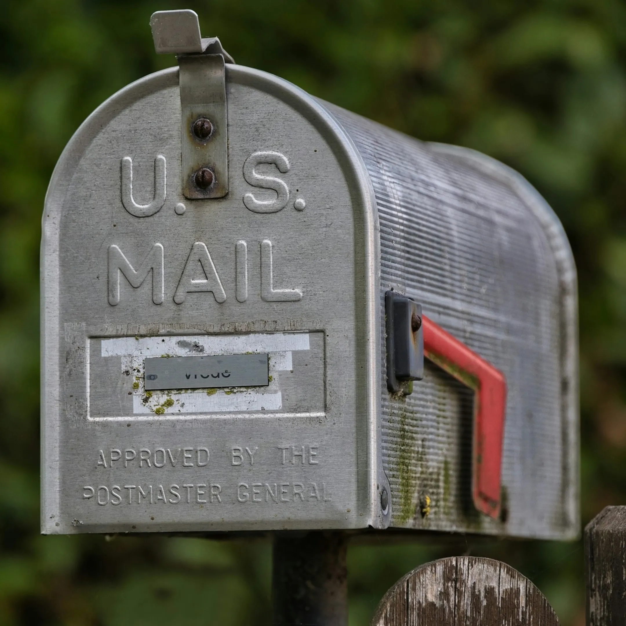 Stacked direct mail postcards prepared with postal barcoding for delivery.