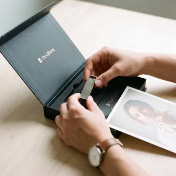 Photographer preparing branded USB gallery delivery